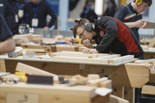 Three apprentices looking at plans